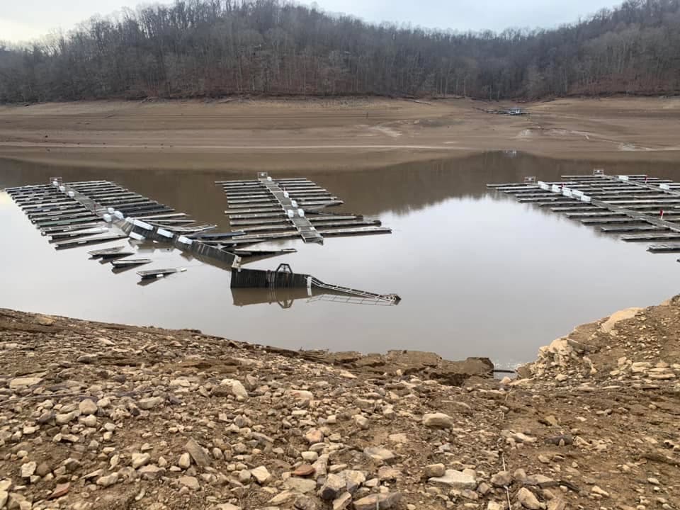 Damaged docks partially submerged at low water